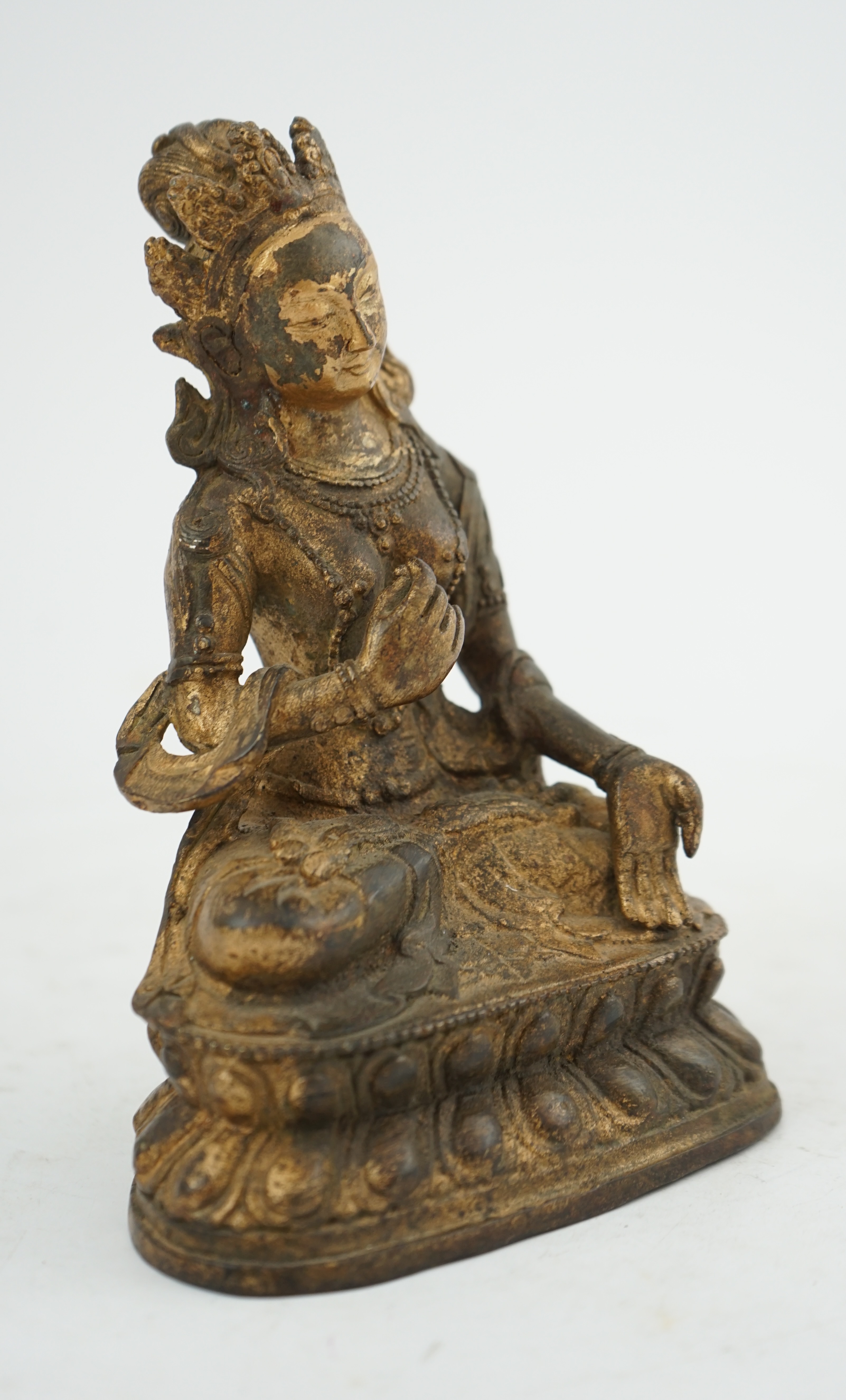 A Tibetan gilt bronze figure of seated Tara, on a double lotus throne, 16.5cm high. Condition - good